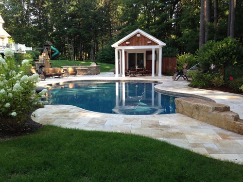 Free Form Pool with Waterfall, Diving Rock, Stone Bar and Travertine Deck