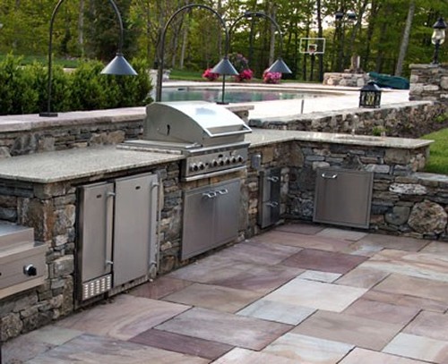 Sunken, L Shaped Stone Bar with Built in Grill, Wok Burner, Refrigerator and Pool with Stone Posts by New View
