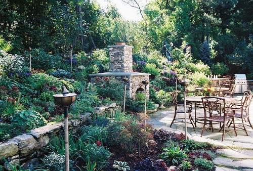 Fireplace with Flat Blue Stone Mantle and Arched Opening; Retaining Wall and Irregular Stone Patio