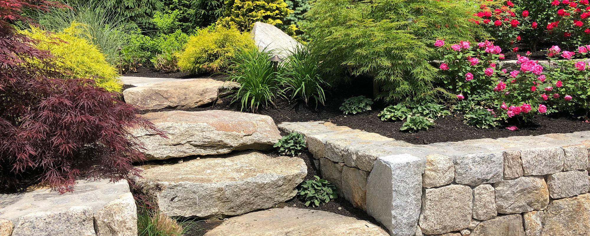 Natural stone steps and granite walls by New View Inc.