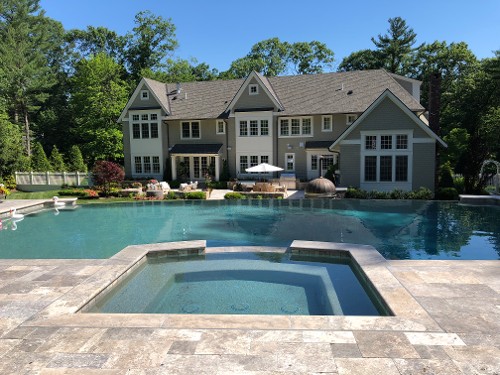 Travertine pool deck,built-in spa and an infinity edge pool