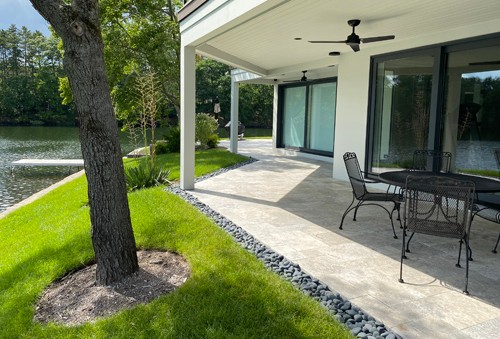 Travertine Patio with Beach Pebble edging by New View